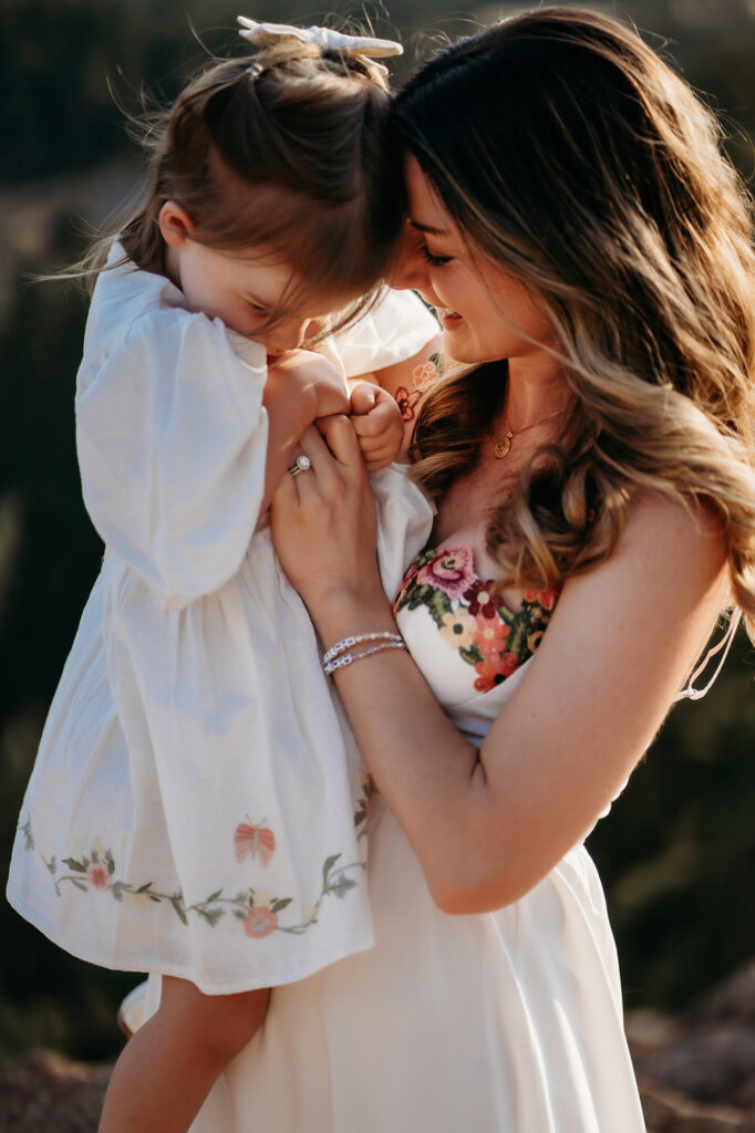 Denver Family Photographer captures mom hugging daughter while wearing white dresses