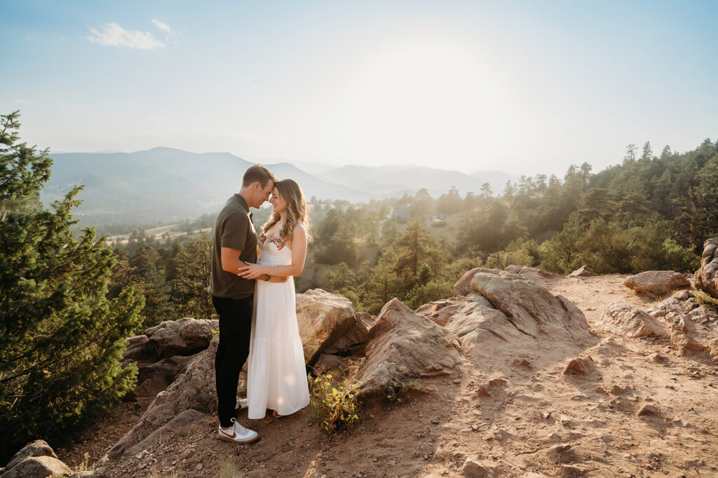 Denver Family Photographer captures mom and dad hugging on mountain during outdoor family photos