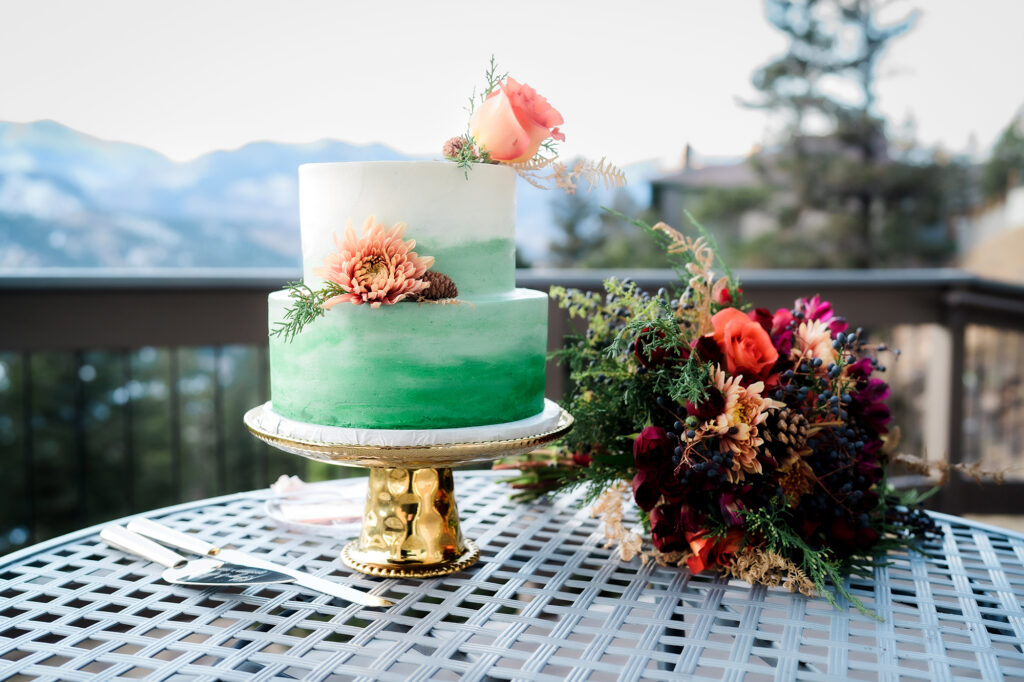 Colorado elopement photographer captures wedding cake with flowers at elopement ceremony