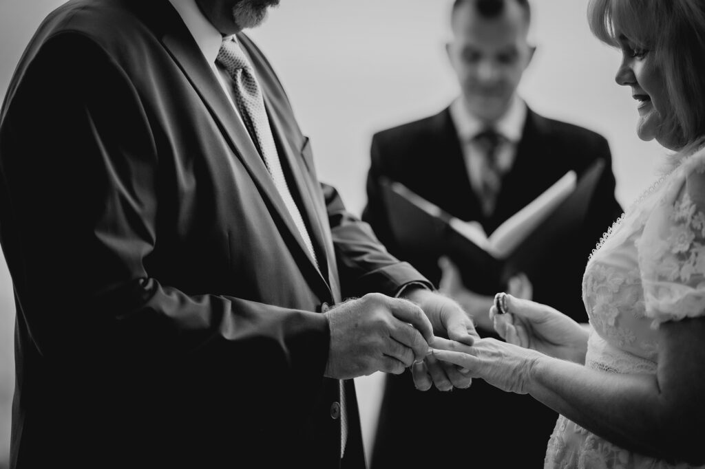 Colorado Elopement Photographer captures husband putting ring on bride's finger