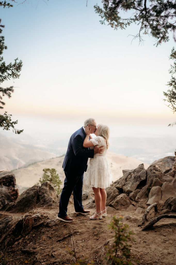 Colorado Elopement Photographer captures bride and groom kissing on top of mountain after Golden Colorado wedding