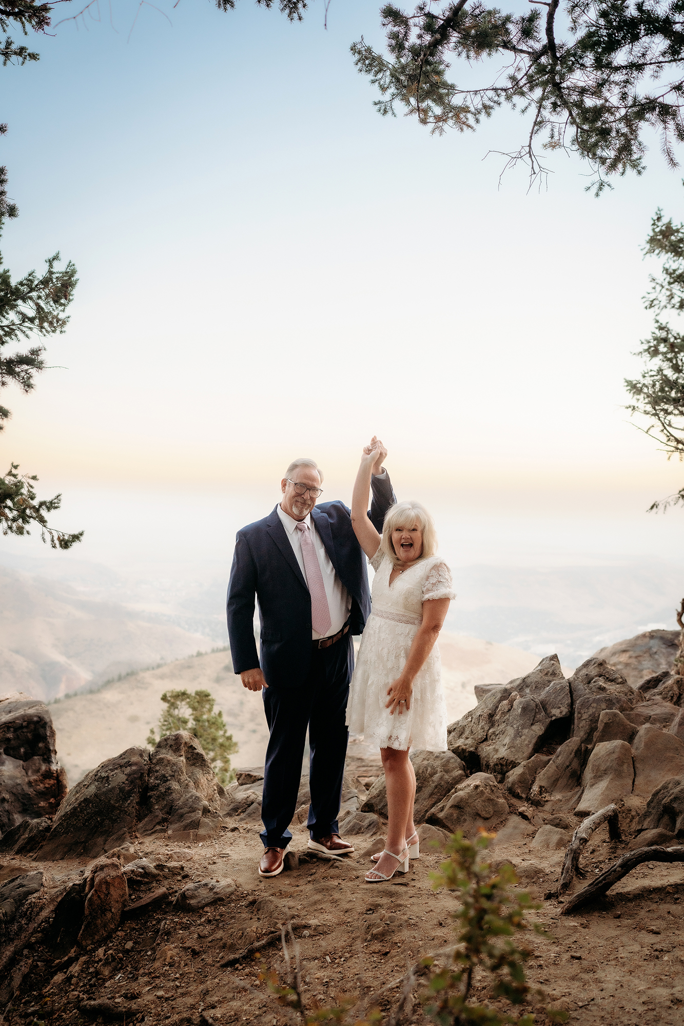 Colorado Elopement Photographer captures bride and groom lifting hands in air to celebrate recent marriage