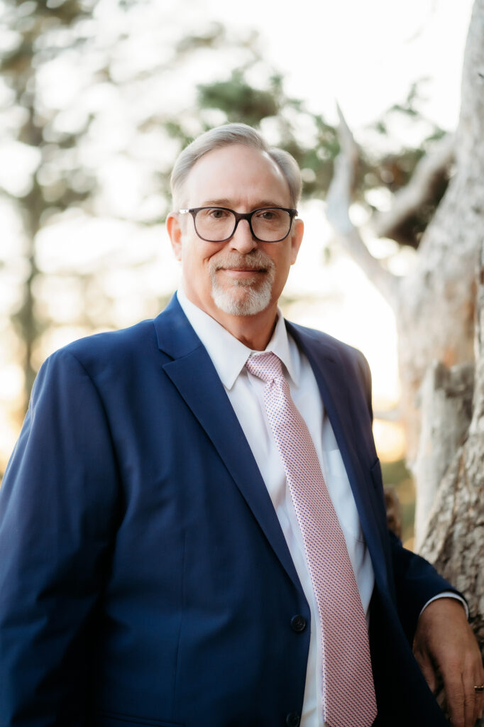 Colorado Elopement Photographer captures groom wearing navy suit and pink tie for Golden Colorado wedding