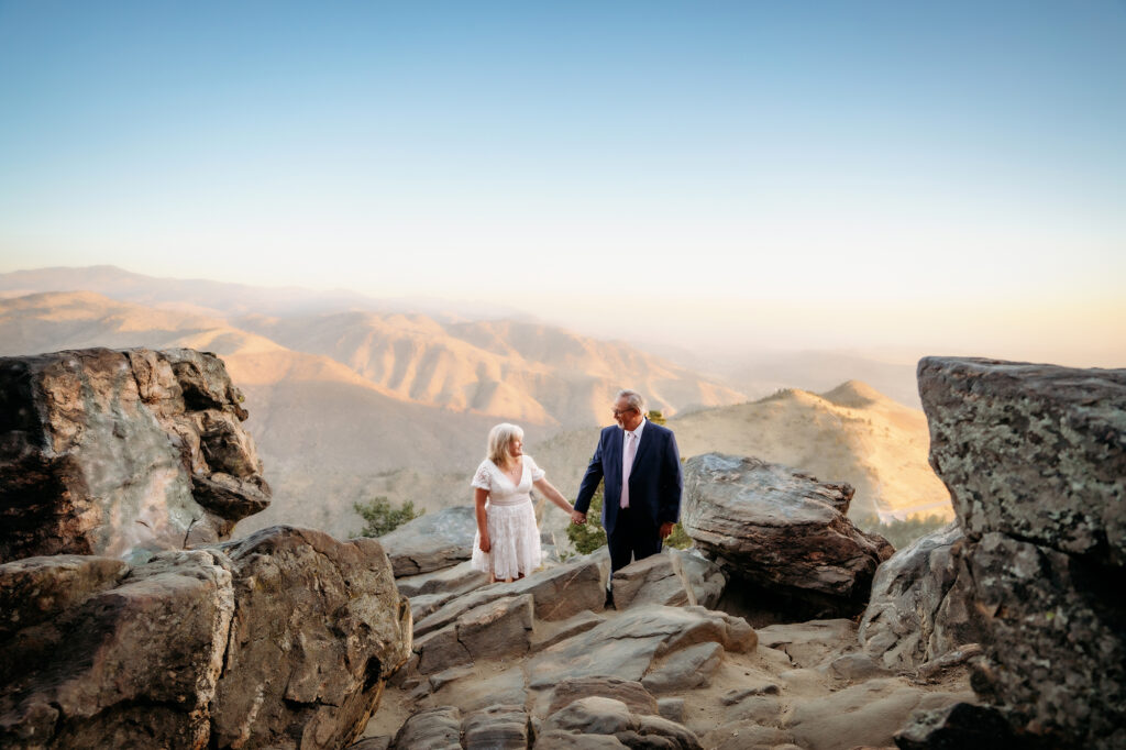 Colorado Elopement Photographer captures bride and groom walking up mountain hand in hand