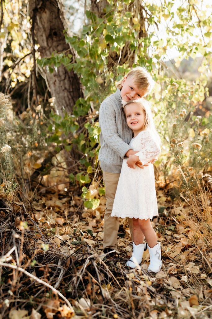 Denver Family Photographer captures brother hugging sister during fall outdoor family photos