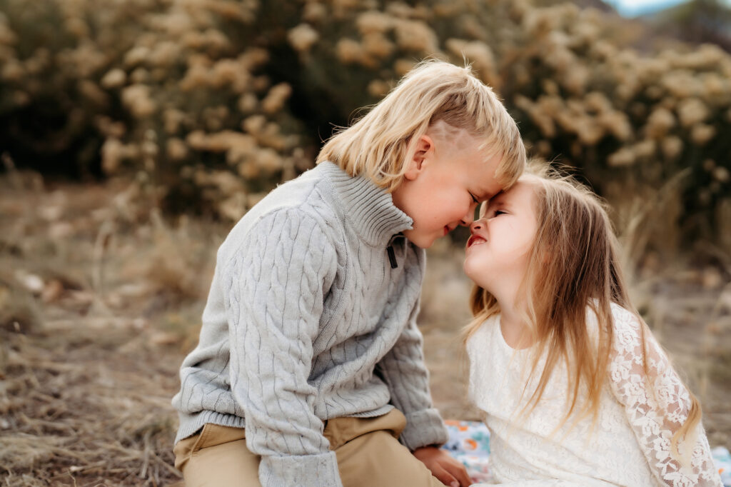 Denver Family Photographer captures brother and sister touching foreheads during family photos