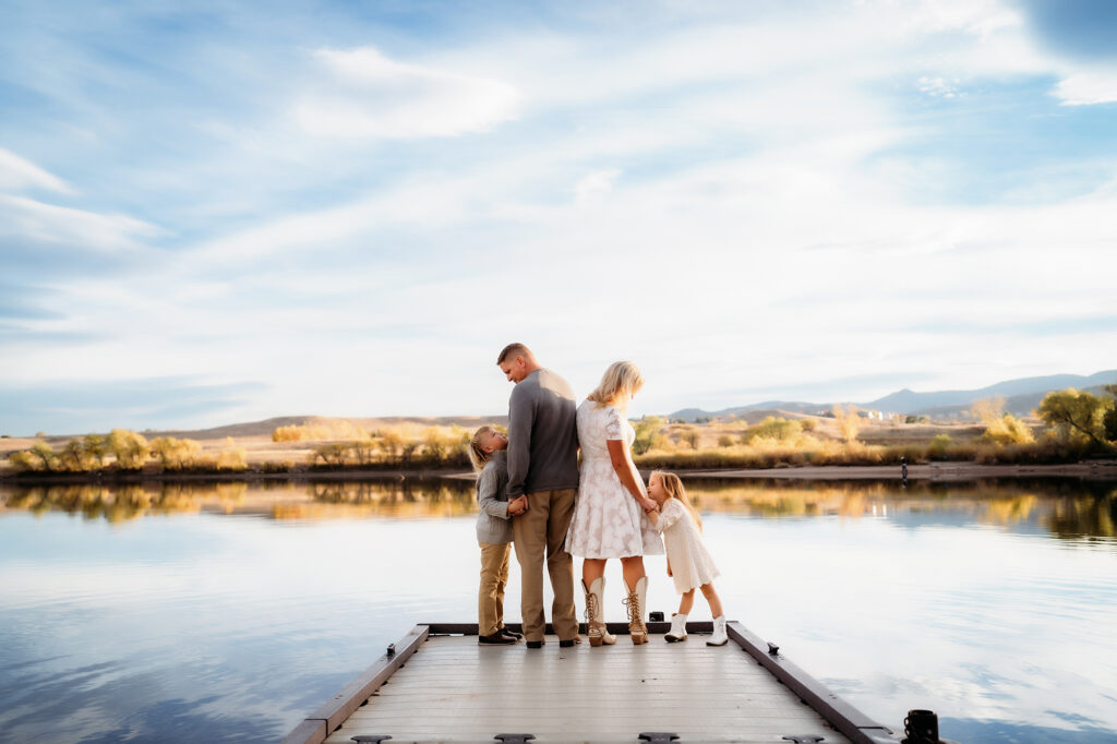 Denver Family Photographer captures family standing on dock looking out onto the water