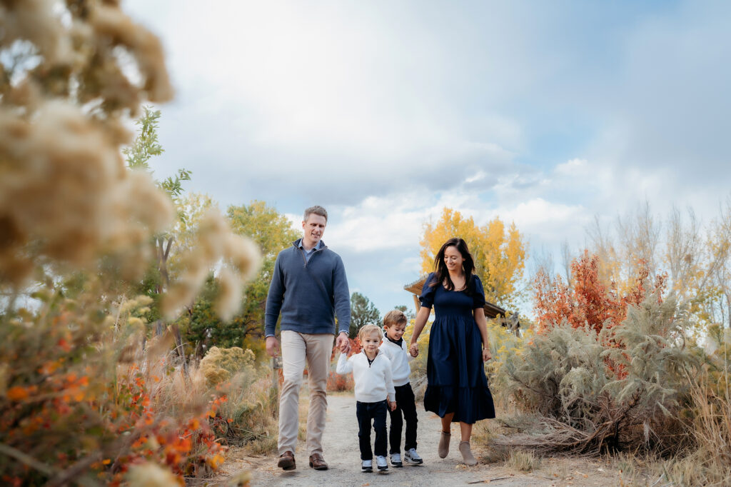 Denver Family Photographer captures young family walking hand in hand through park