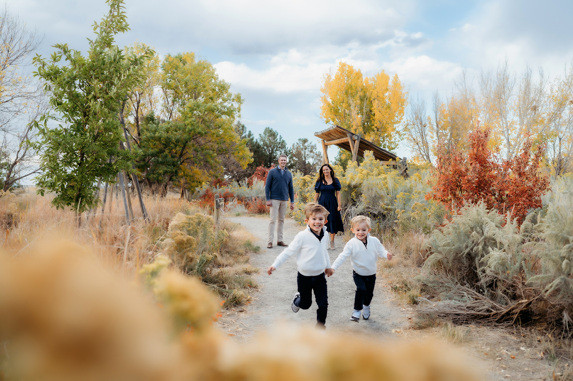 Denver Family Photographer captures children running from parents during outdoor family photos in Denver Colorado