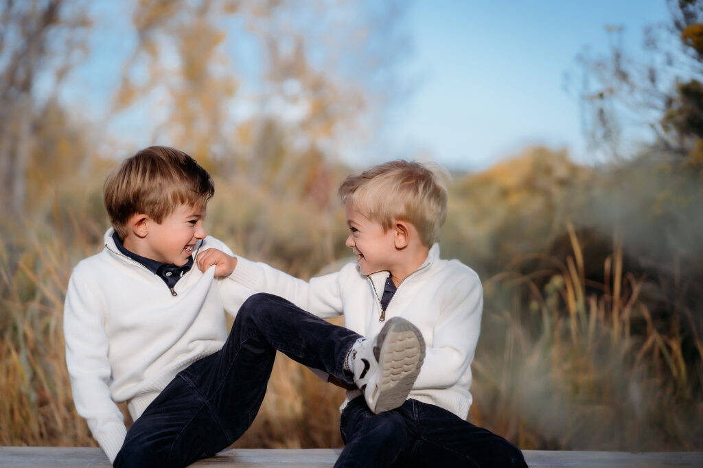 Denver Family Photographer captures young brothers fighting during outdoor family photos