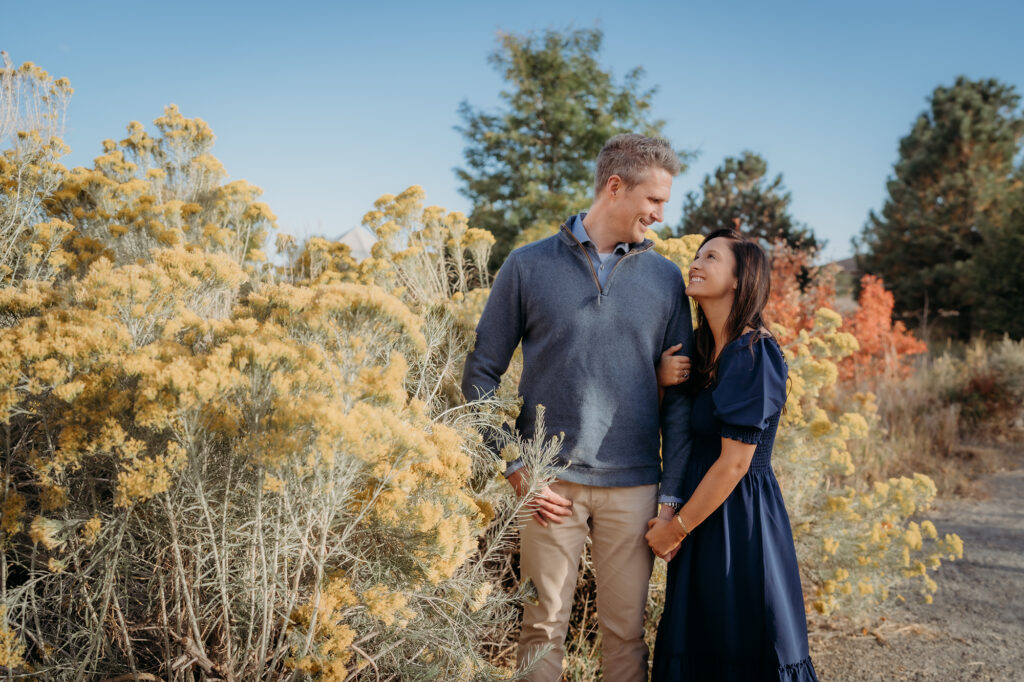 Denver Family Photographer captures parents embracing in front of wild grass field