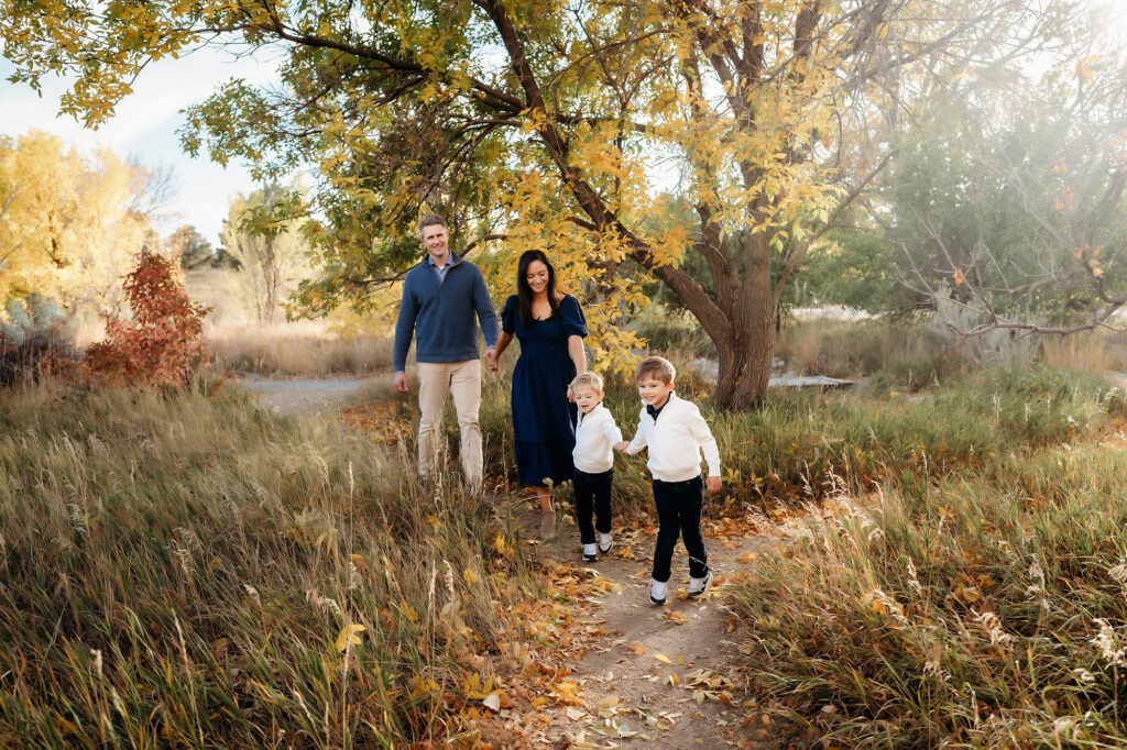 Denver Family Photographer captures family walking through grass holding hands