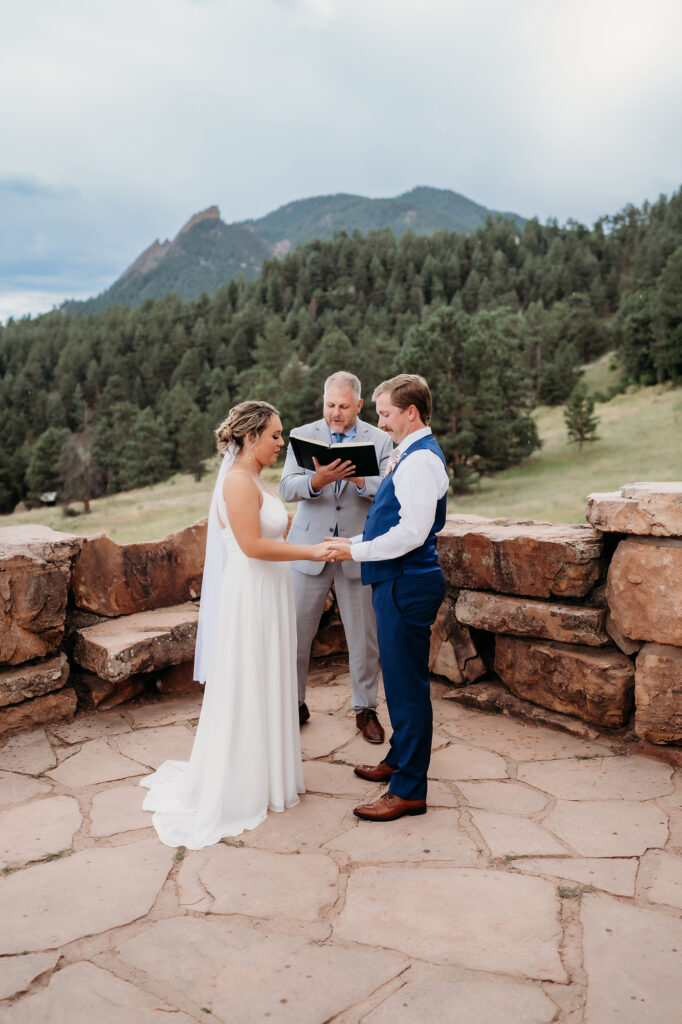 Colorado Elopement Photographer captures bride and groom holding hands during intimate elopement ceremony