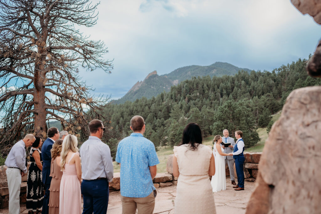 Colorado Elopement Photographer captures guests standing together watching intimate Colorado elopement