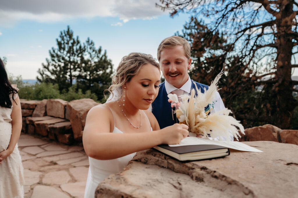 Colorado Elopement Photographer captures bride signing marriage license