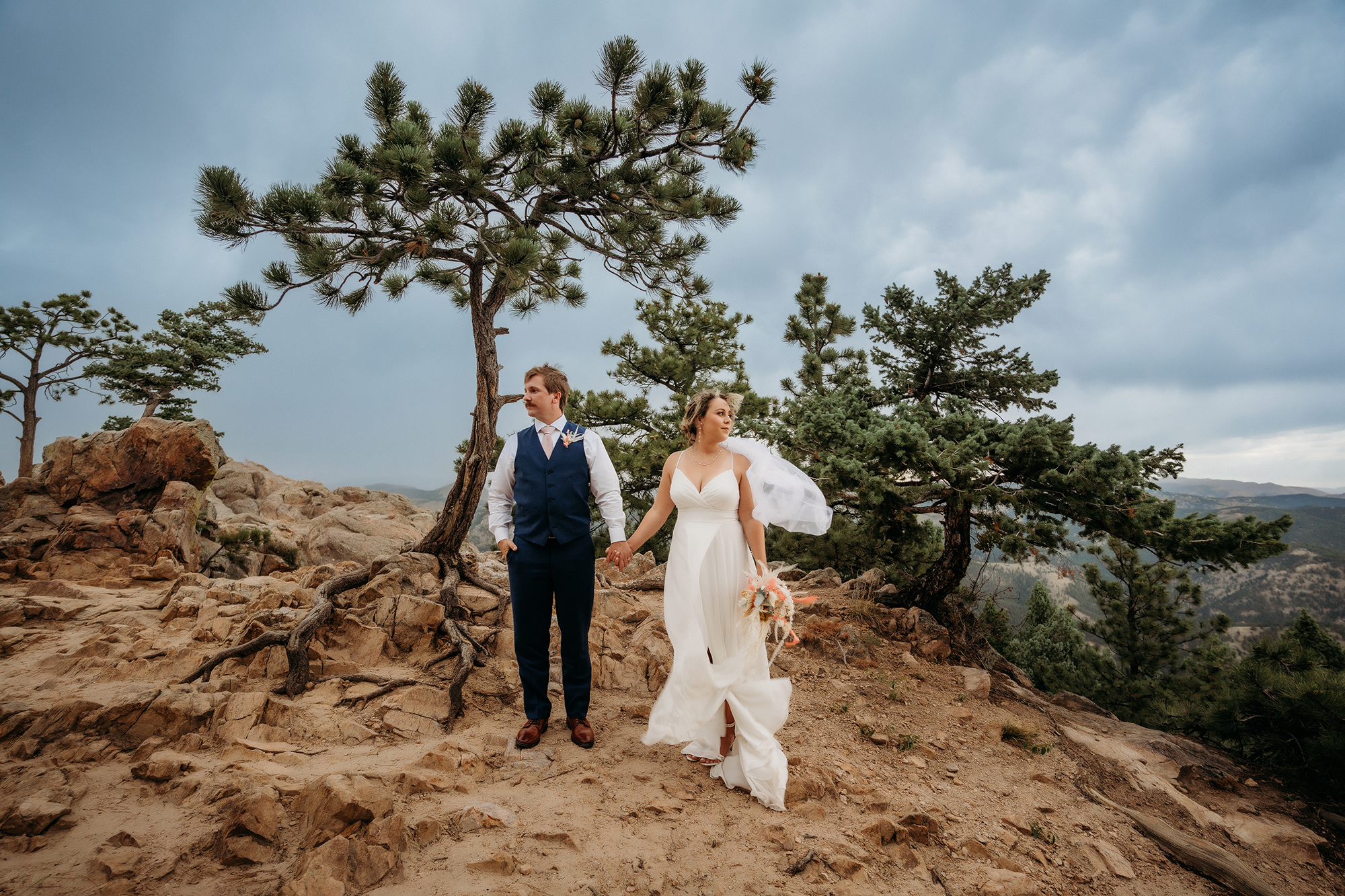Colorado Elopement Photographer captures bride and groom standing on top of mountain after eloping in Colorado