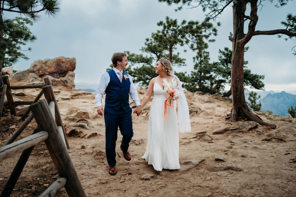 Colorado Elopement Photographer captures bride and groom holding hands and walking during bridal portraits