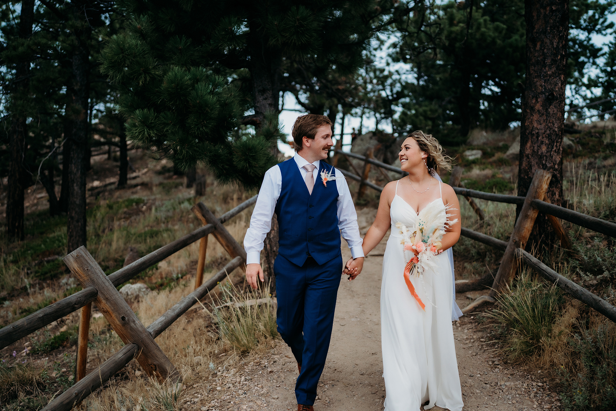 Colorado Elopement Photographer captures bride and groom walking hand in hand after intimate elopement ceremony