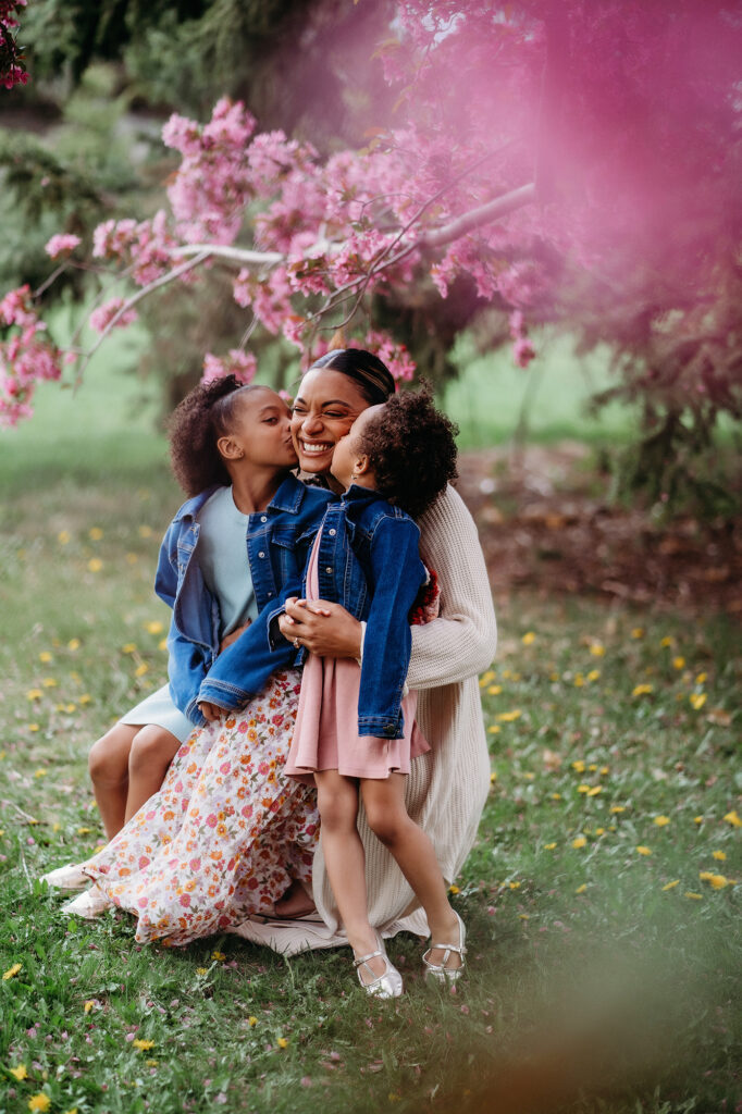 Denver Family Photographer captures children kissing mother on cheek during outdoor family photos