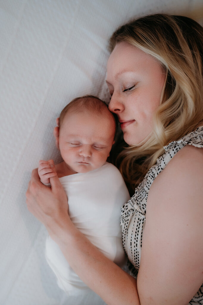 Denver Family Photographer captures mother laying with child in bed