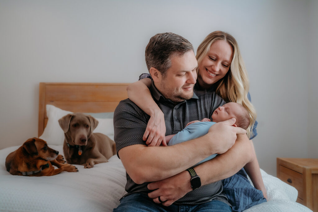 Lifestyle photographer based in Colorado captures family sitting in bed before lifestyle photos in home