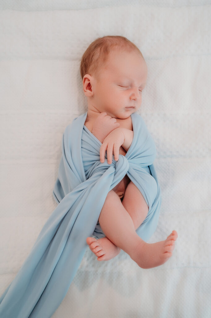 Denver Family Photographer captures baby swaddled in baby swaddle during at home lifestyle family photos