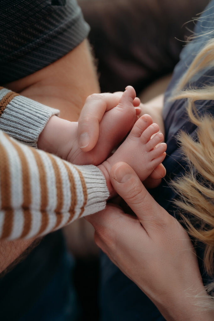 Denver Family Photographer captures parents holding baby feet