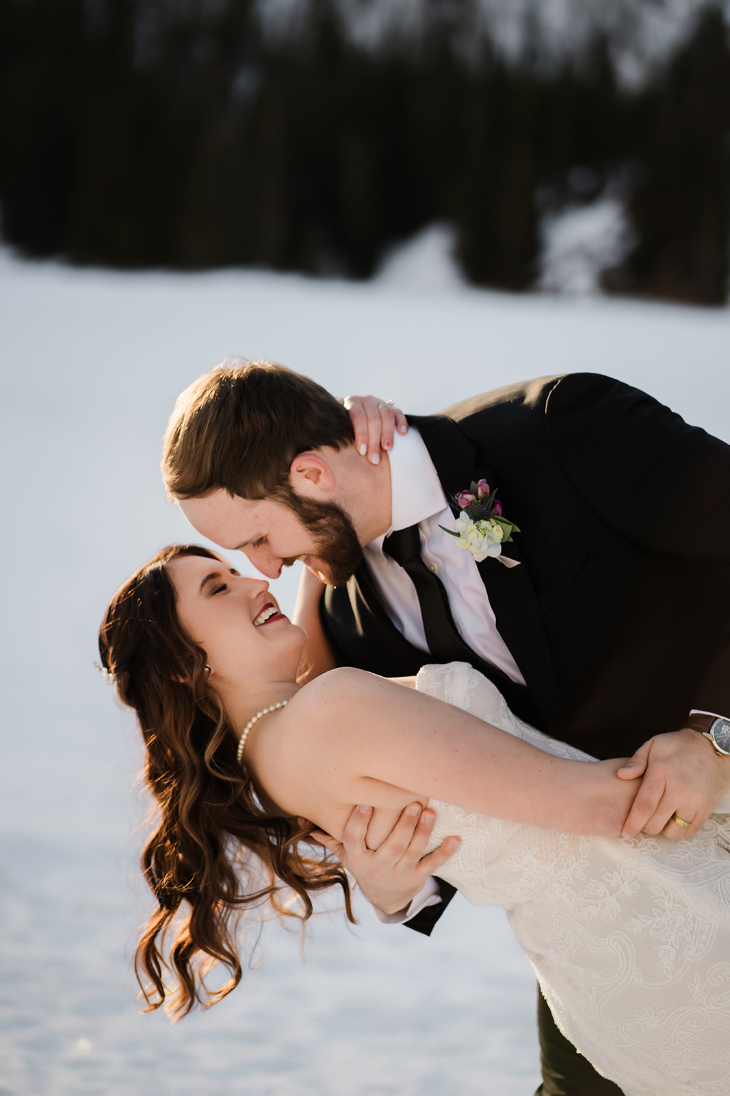Colorado Elopement Photographer captures couple dip kiss after winter Colorado elopement