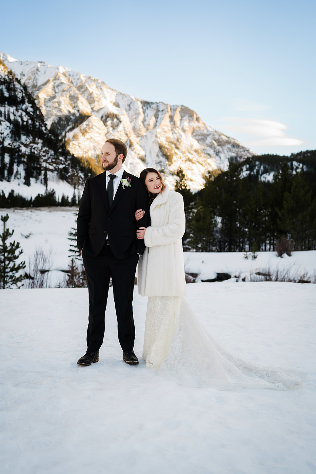 Colorado Elopement Photographer captures bride holding groom's arm during portraits