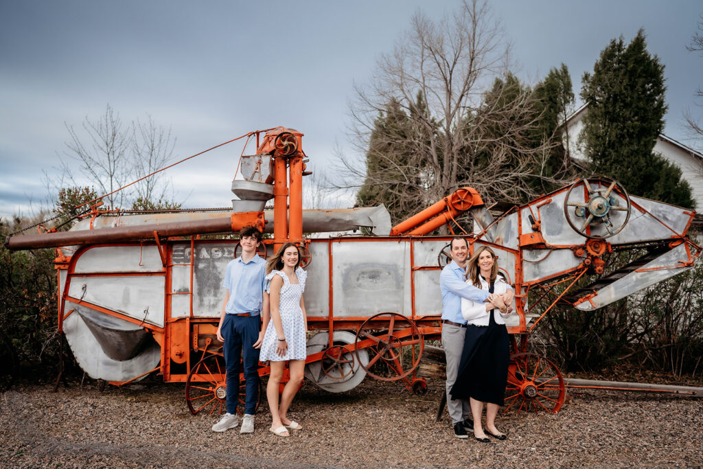 Colorado Family Photographer captures young family standing in front of structure during photos