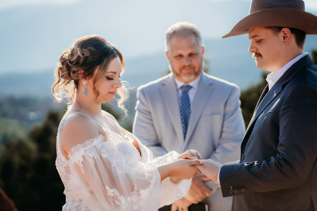 Colorado Elopement Photographer captures bride and groom exchanging rings and vows at Colorado elopement
