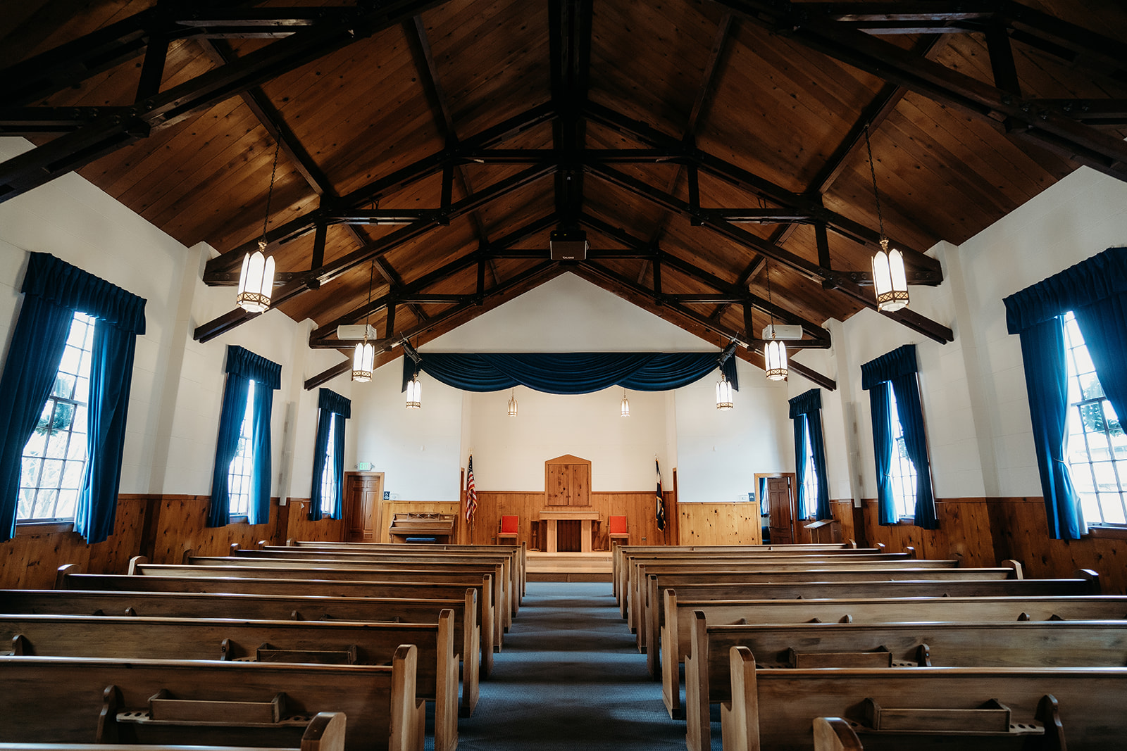 Interior of Eisenhower Chapel, a historic Denver venue with wooden pews and exposed beams, perfect for a small wedding in Colorado.