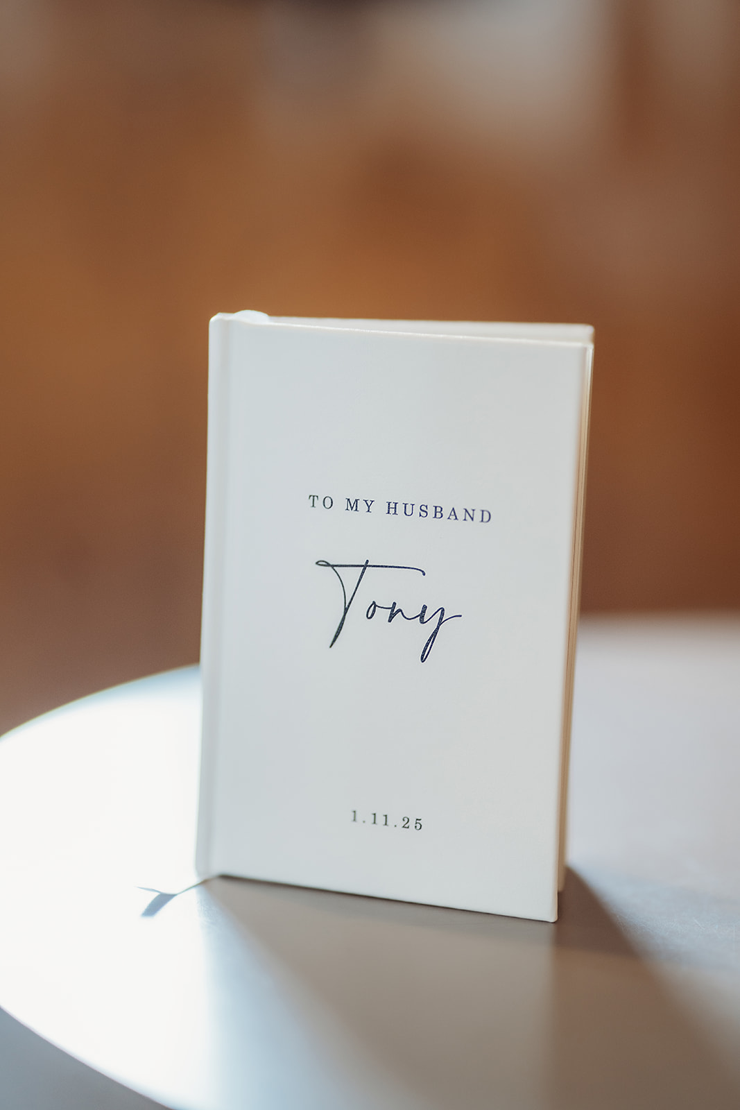 Personalized vow book titled “To My Husband Tony,” captured in soft light on the morning of the ceremony.