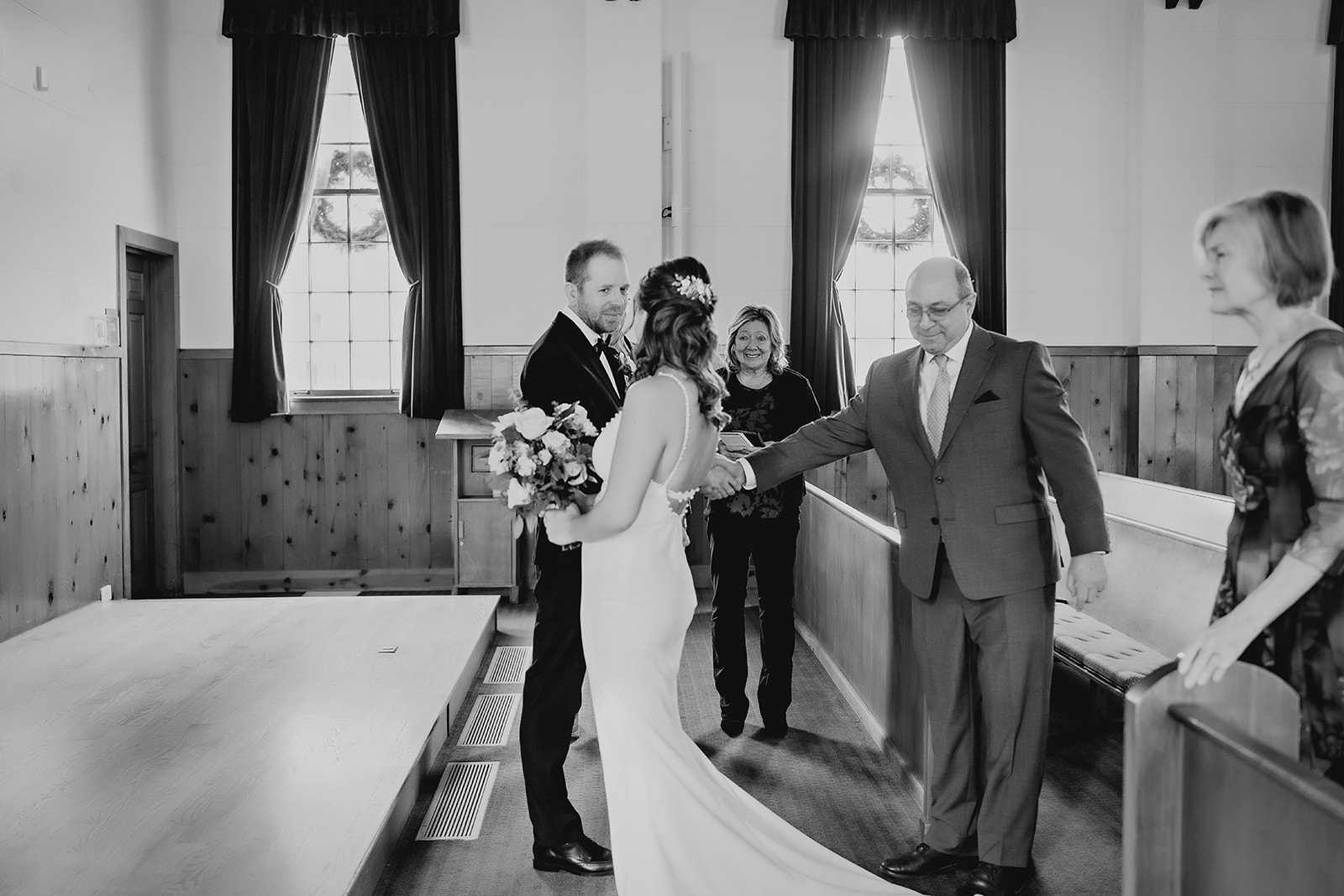 Emotional black-and-white moment as bride is walked down the aisle and given away during a small wedding in Colorado.