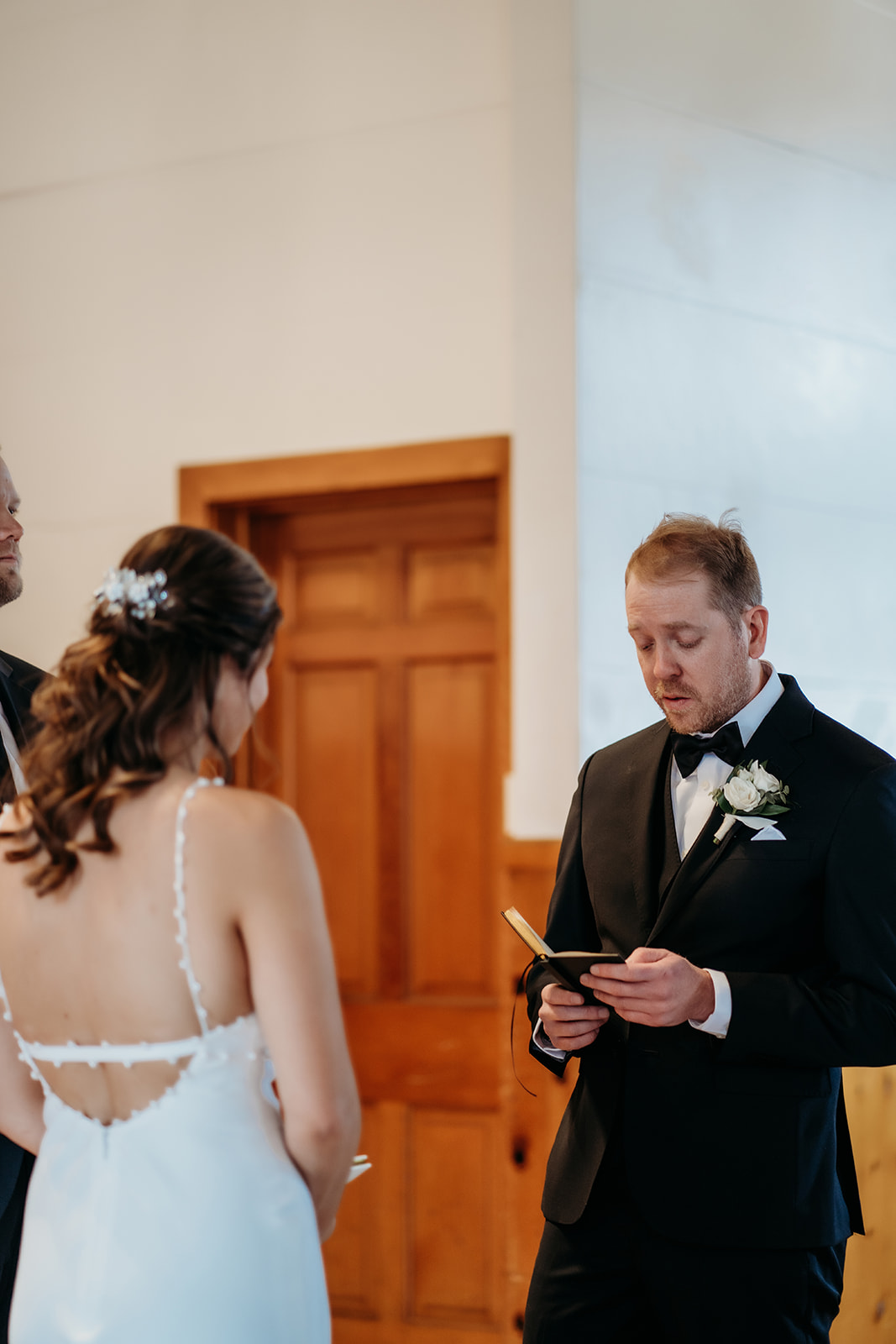 Groom reading heartfelt vows to his bride during an intimate moment inside Eisenhower Chapel.