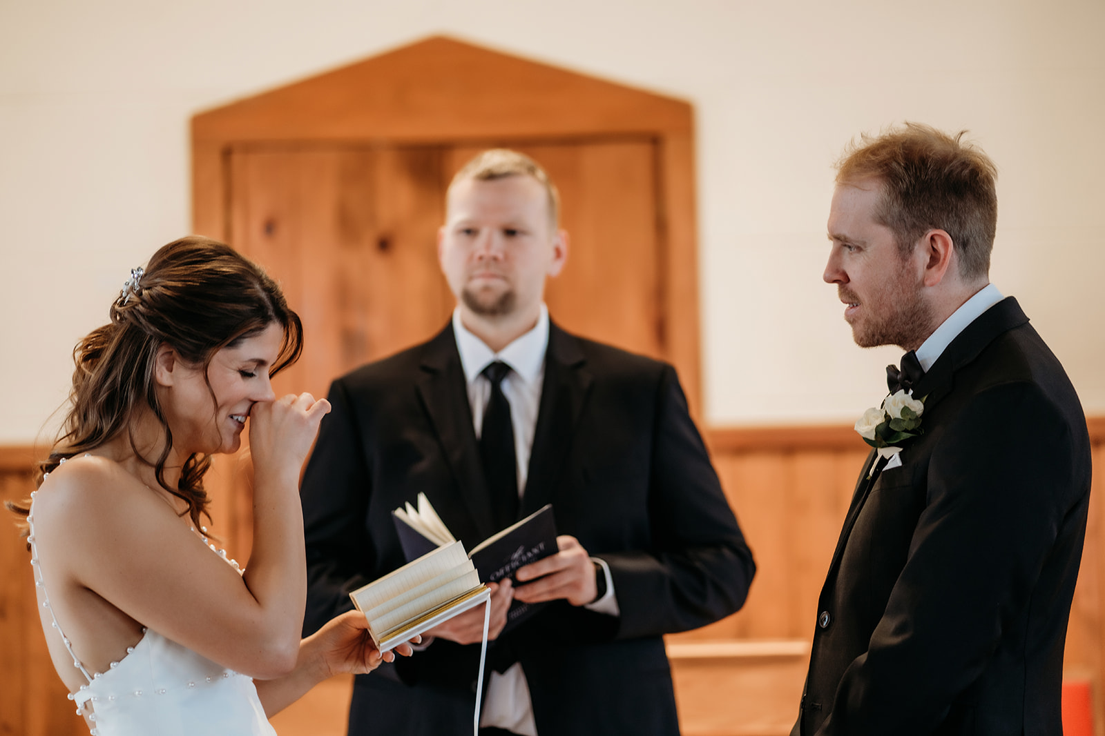 Bride fights happy tears while reading her vows, a deeply personal moment during this small wedding in Colorado.