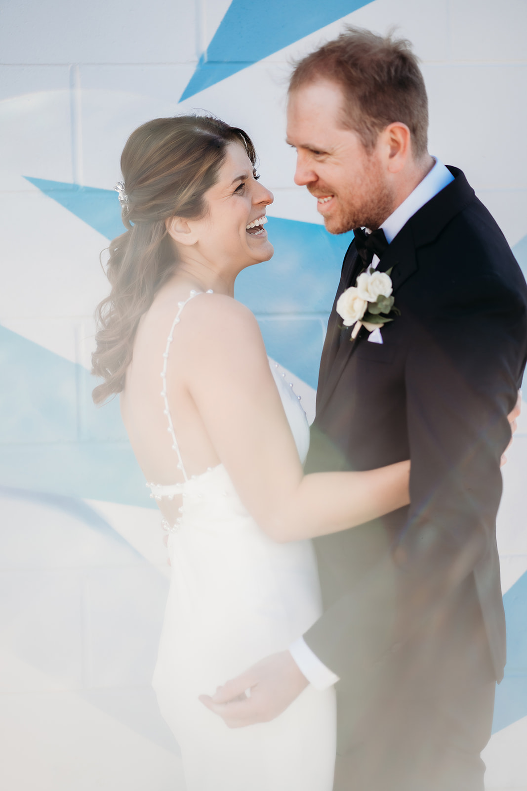 Bride and groom laugh joyfully after their ceremony, celebrating their small wedding in Colorado with genuine connection.