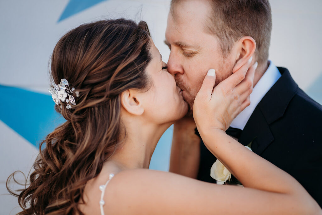 Emotional close-up of a newlywed couple sharing a kiss, capturing the intimacy of their small wedding in Colorado.