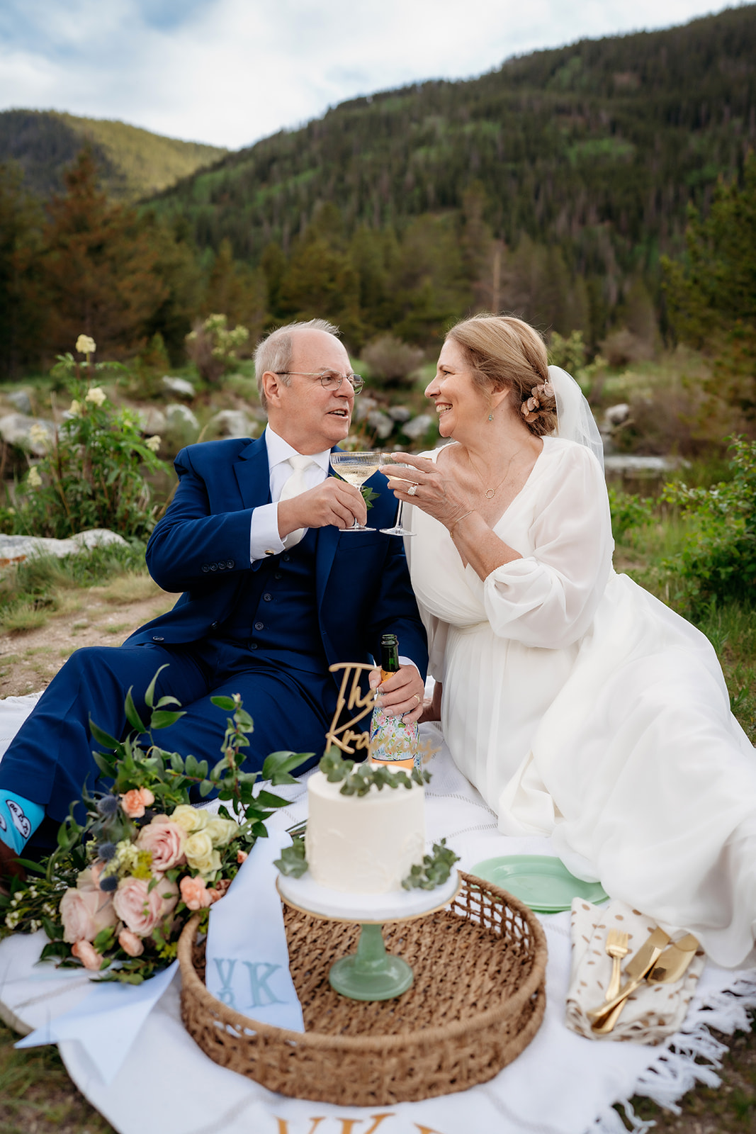 A joyful moment of connection as the bride and groom toast to forever in the middle of nature’s beauty.