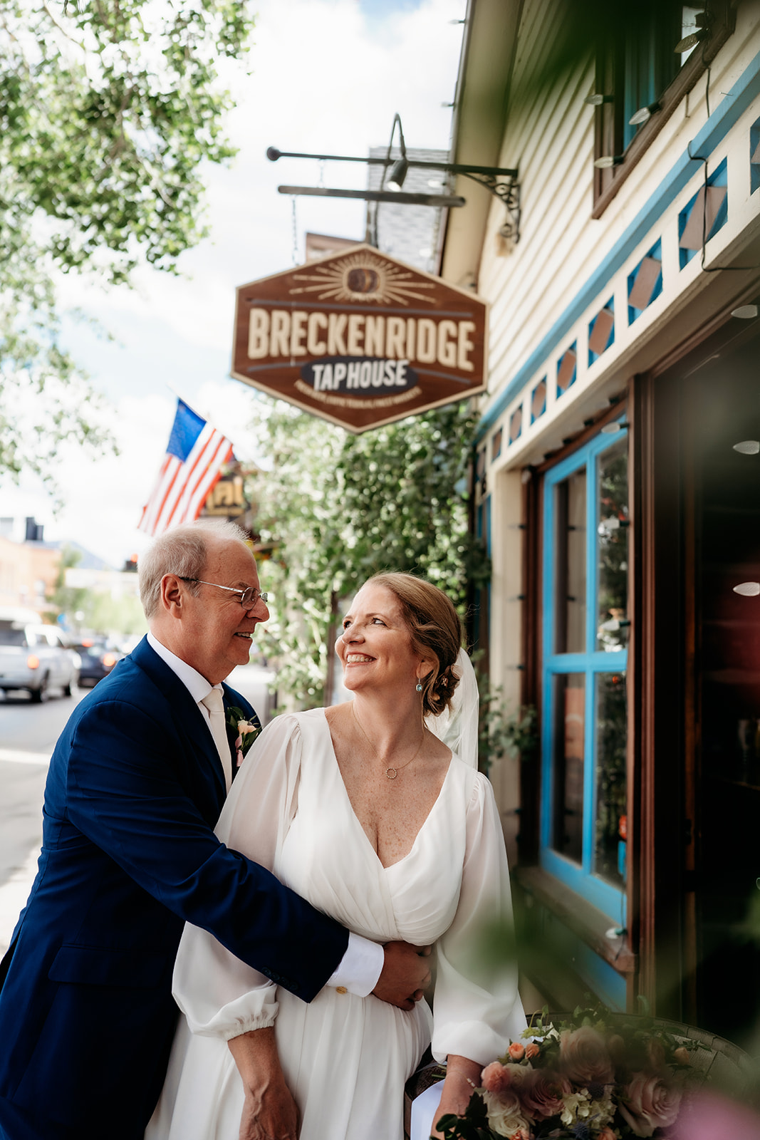 A joyful moment between the bride and groom outside a local tap house, captured during their post-ceremony stroll.