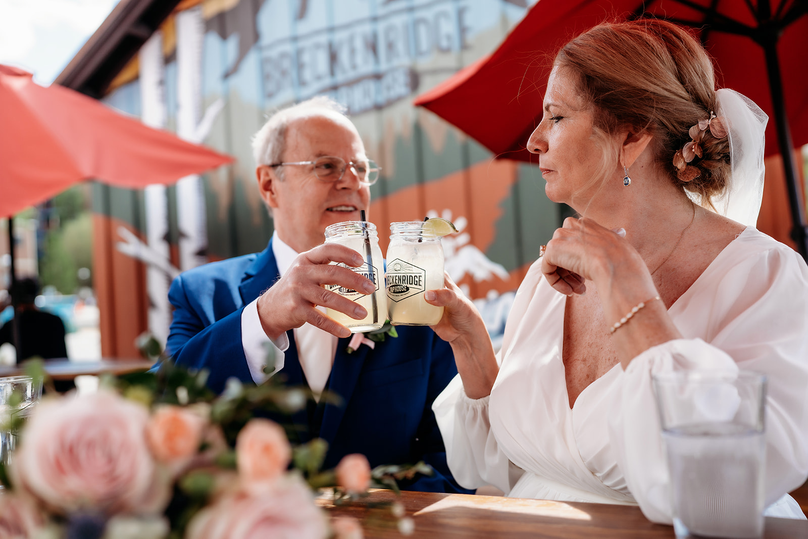 Newlyweds toast with signature drinks at a local brewery—showing How to Make Your Elopement Special by savoring local favorites.