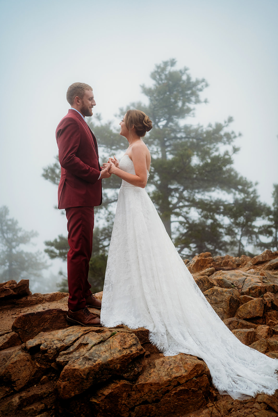 Couple exchanging a tender look on a mountaintop, capturing the essence of how to plan an elopement.