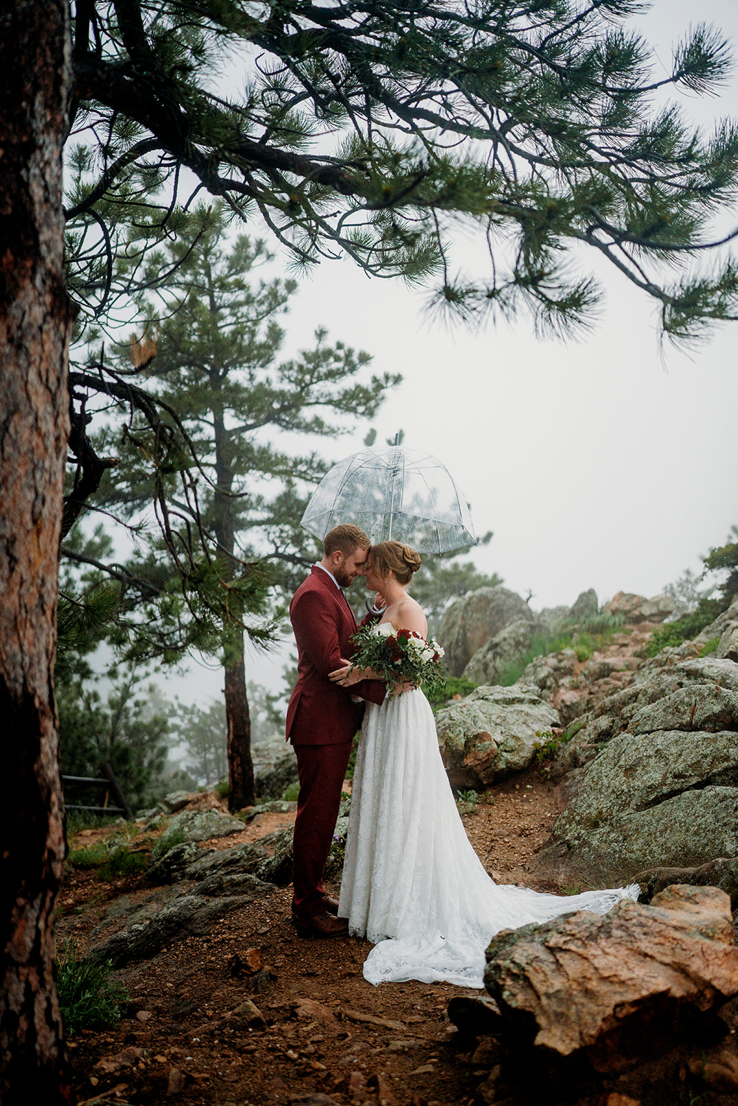 Bride and groom sharing an intimate moment in a misty forest, an example of how to plan an elopement outdoors.