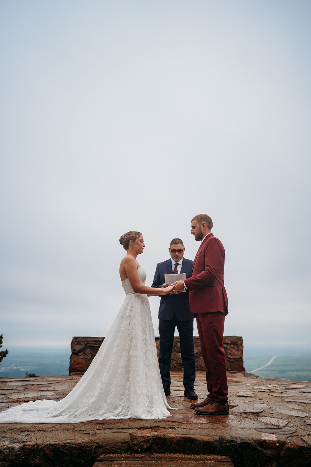 Bride and groom hold hands during vows at their outdoor ceremony, a tender example of How to Plan an Elopement with intention.