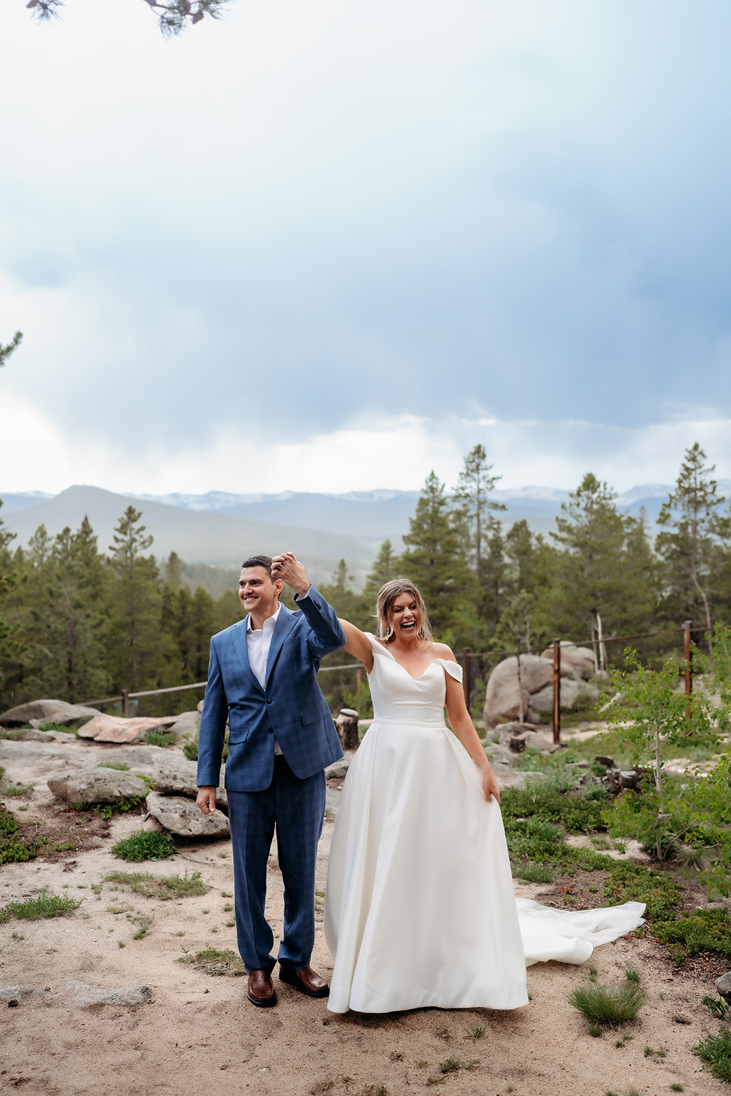 Bride and groom raising joined hands in celebration during their Colorado adventure elopement.