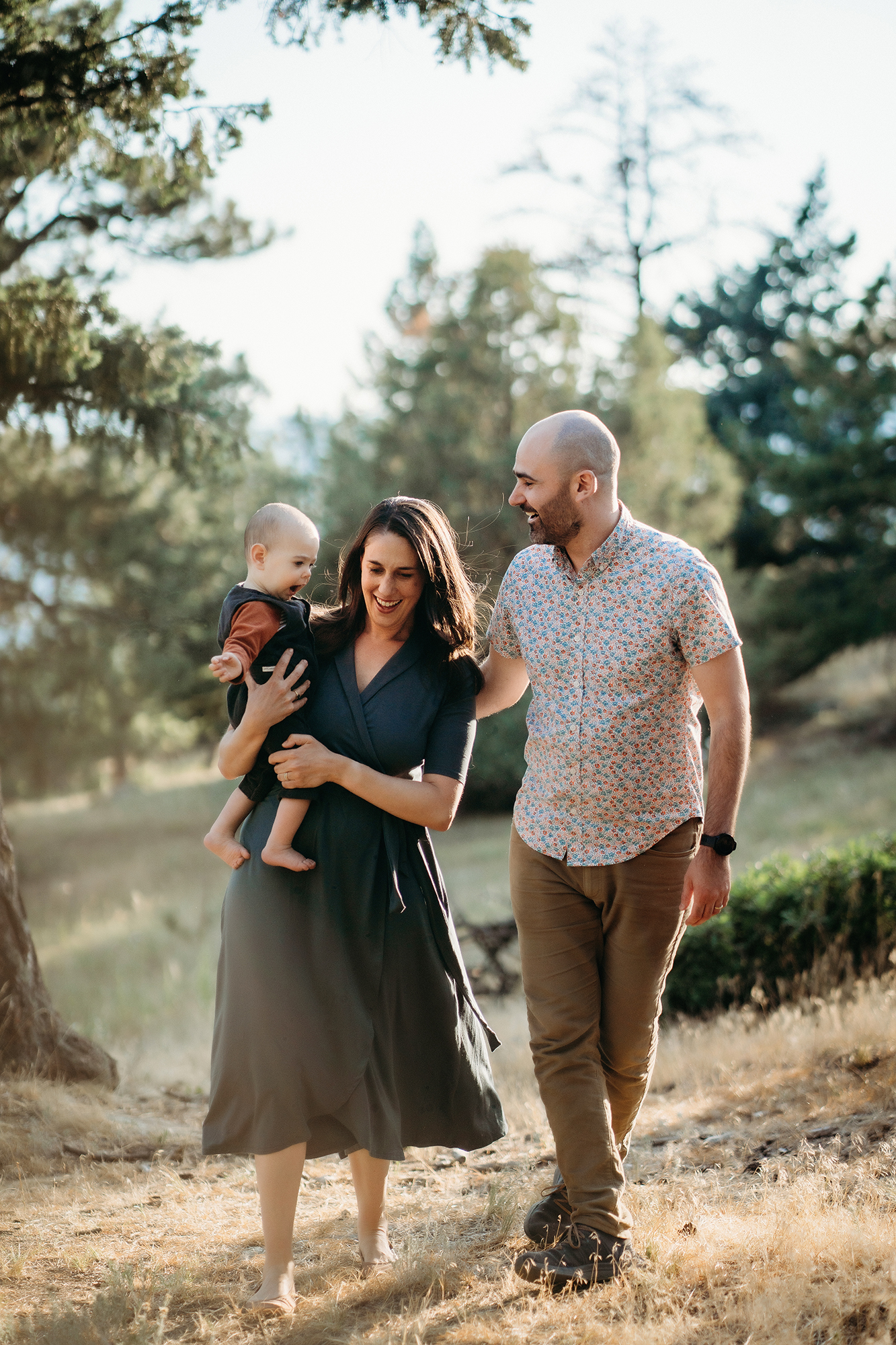 A family walking together outdoors, wearing coordinated casual outfits for family photos in nature.