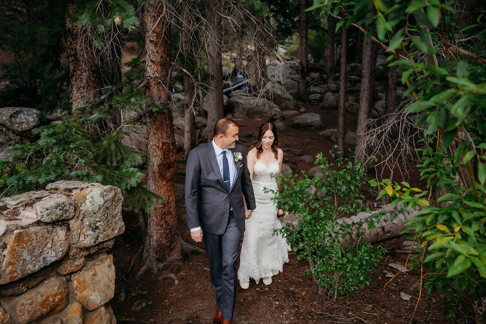 Walking hand-in-hand through the forest, this couple explores the beauty of their elopement in Colorado.