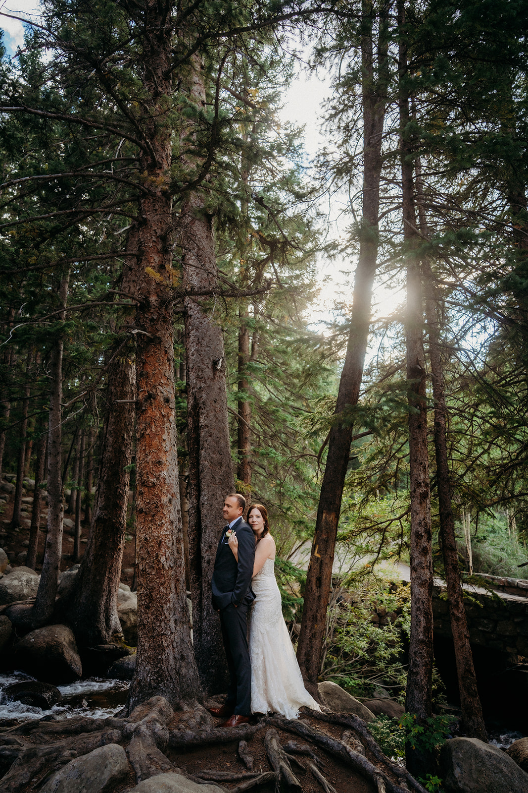 Back to back under towering pines, the couple finds calm in the woods before saying “I do.”