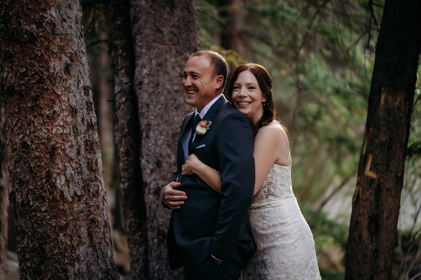 Laughing together with trees towering around them, this elopement in Colorado was full of joy and natural connection.