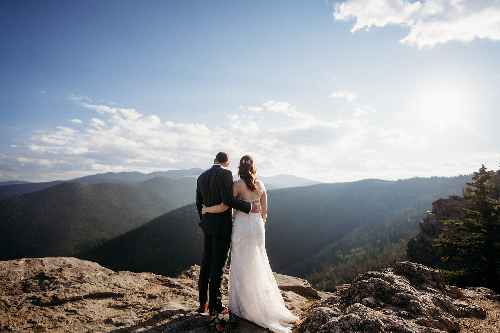 Arm in arm, they take in the sweeping views—this mountaintop moment perfectly captures the spirit of an elopement in Colorado.